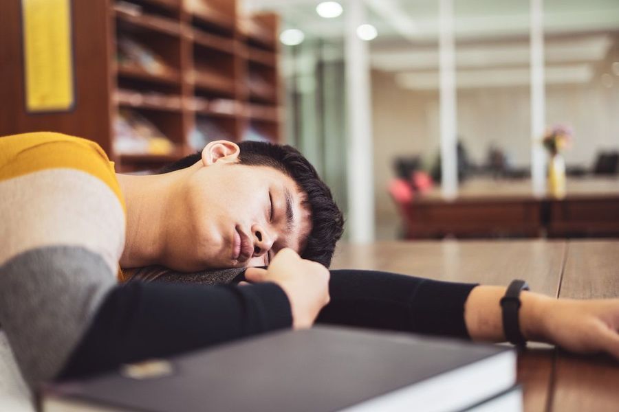 رجل ينام في المكتبة